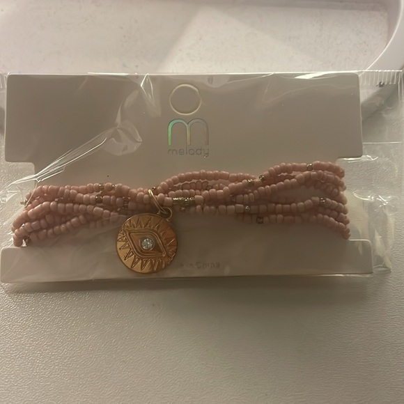 Super cute pink stretchy bracelet with gold charms. - Picture 2 of 4